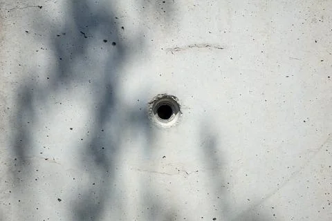 A pristine white surface showcasing a circular hole located centrally Stock Photos