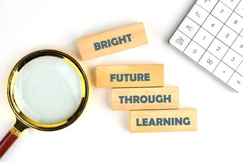 On a pristine white surface, wooden blocks with text BRIGHT FUTURE THROUGH LE Stock Photos