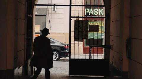 Privat detective in hat walking out from the building Stock Footage 166151730