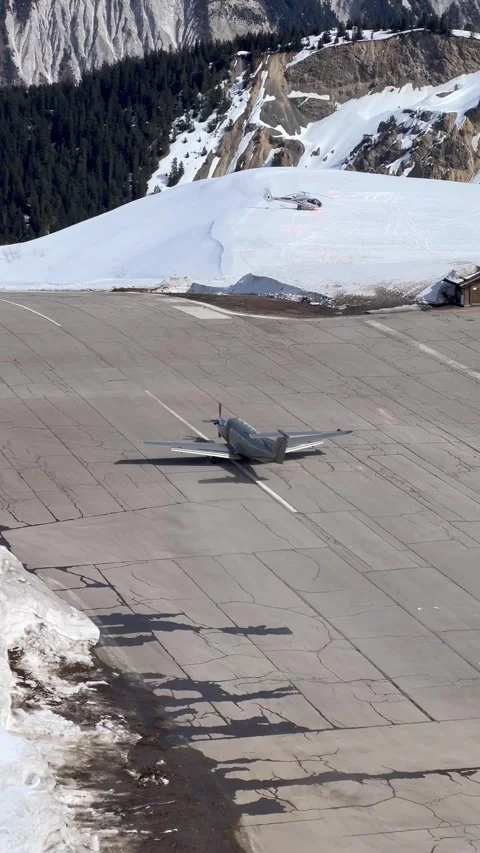 Private airplane taking off from Courchevel ski resort airport by winter Stock Footage 336914201