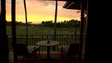 Private balcony overlooking golf course and ocean with beach sunset Stock Footage 125333032