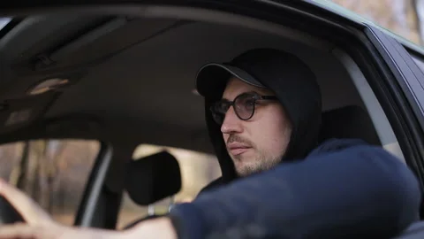Private detective man sitting inside car and photographing with dslr camera Stock Footage 100649899