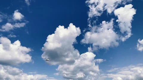 A private helicopter flies alone in an empty sky against a backdrop of huge Stock-Footage 246382955