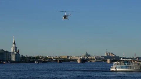 Private helicopter flying over river inside city Stock Footage 103288261