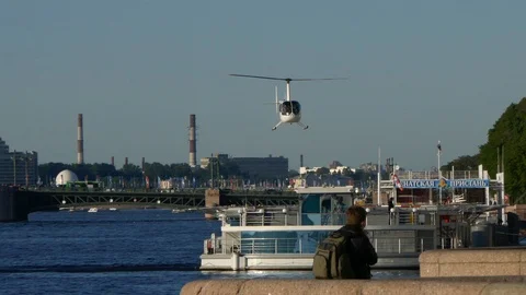 Private helicopter landing on river inside city Stock Footage 103288241