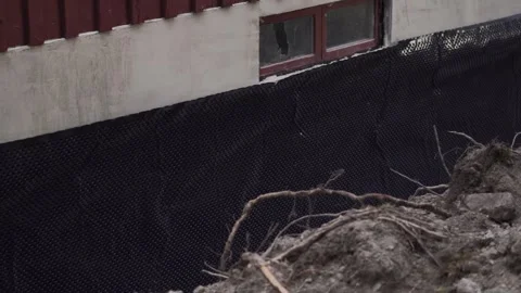 Private home foundation waterproofing and insulation installed around exterior Stock Footage 337603712
