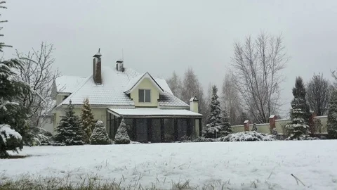 Private house with garden under snow in a snowy day in winter Stock Footage 83729045
