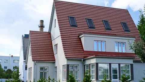 A private house of two floors with triangular roof and an area near the house Stock Photos