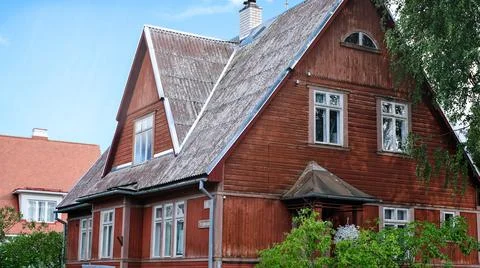 A private house of two floors with triangular roof and an area near the house Stock Photos