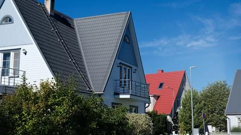 A private house of two floors with triangular roof and an area near the house Stock Photos