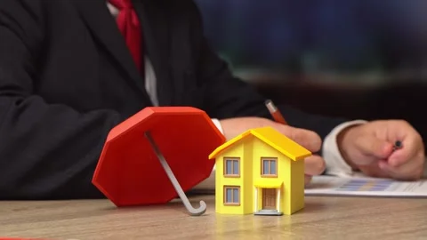 A private house under a red umbrella. Property and real estate insurance with Video stock 342813477