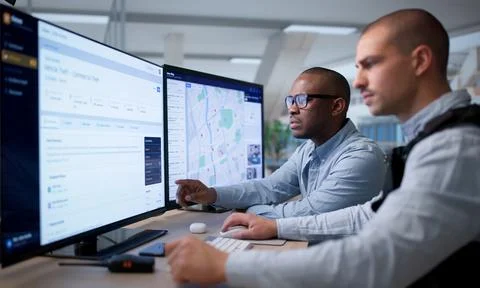 Private Investigator Studies Computer Files To Track Crime Patterns Closely. 스톡 사진