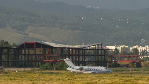Private jet on the airfield, side view Stock Footage 284944399