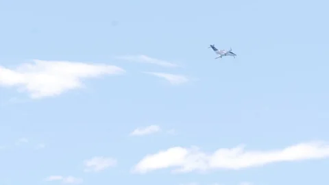 A private jet flies through a blue sky Stock Footage 112005479