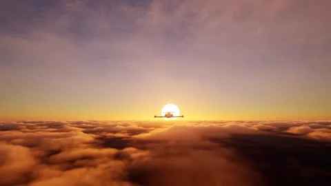 Private jet flying into the sunset above clouds. Stock Footage 330068810