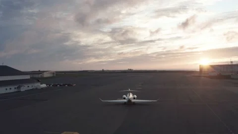 Private jet taxiing towards runway on Iceland airport during perfect sunset Stock Footage 140993404