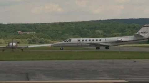 Private jets and small jets on runway and parked Stock Footage 8968009