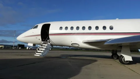 Private jet’s exterior fuselage deployed stairs scene luxury vip transport slow Stock Footage 293738326