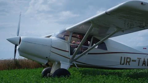 Private plane started engine standing on field. Airplane parked on grass. 写真素材