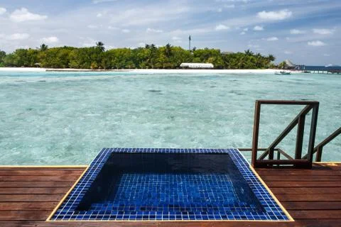 Private pool at balcony facing crystal clear water on water villa Stock Photos