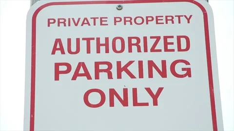 Private property authorized parking only sign, red writing on white background Stock Footage 248247964