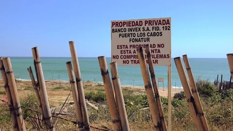 Private property warning sign on beachfront property. Los Cabos, Mexico Stock Footage 109138014