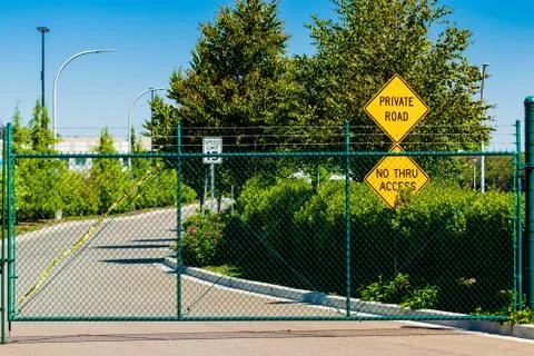 Private road no through access signs behind a fence Stock Photos