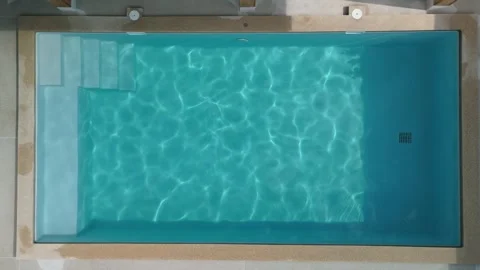 Private rooftop pool under open sky. Turquoise rectangular swimming pool with Stock Footage 312744203