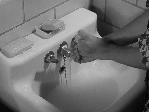 A private in the Women's Army Corps washes her hands and polishes her Stock Footage 75285423