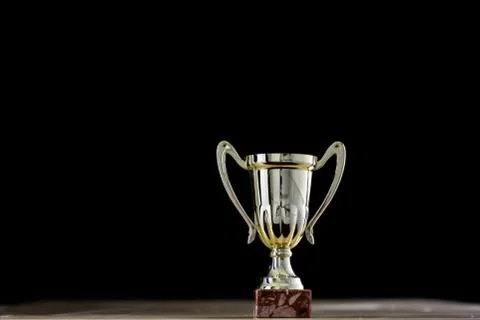 Prize, a cup standing on the table. Cup award on a black background. 写真素材