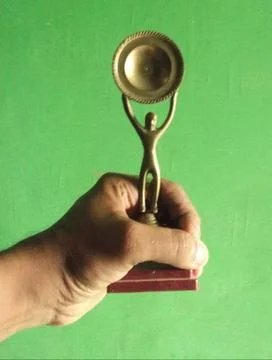 The prize is holding by hands in the function Stock Photos