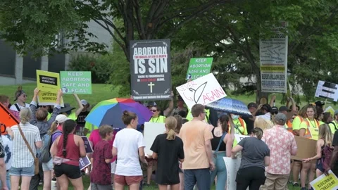 Pro abortion protesters hold up signs in front of anti abortion protesters at Video stock 201951632