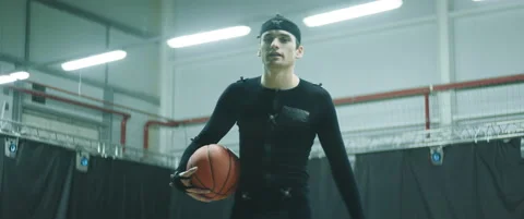 Pro basketball player in motion capture suit posing during the mocap shot Stock Footage 166140054