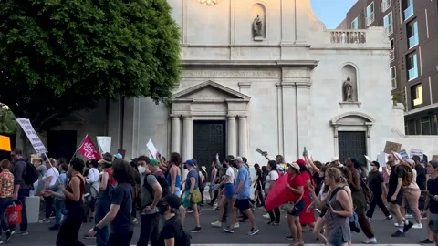 Pro Choice Crowd March Past a Church While Protesting Abortion Rights Stock Footage 198472859
