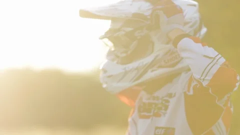 Pro cross biker dressing up riding off Stock Footage 88437224