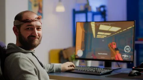 Pro cyber man looking at camera before playing space shooter games 写真素材