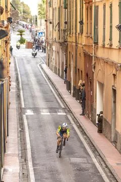 Pro Cyclist Racing Down Narrow Street During Milano-Sanremo in Imperia Stock Photos