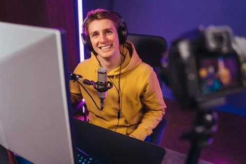 Pro gamer recording vlog while playing computer video game Stock Photos