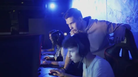 Pro Gamers trainer Explains Strategy to his apprentice Stock Footage 136393108