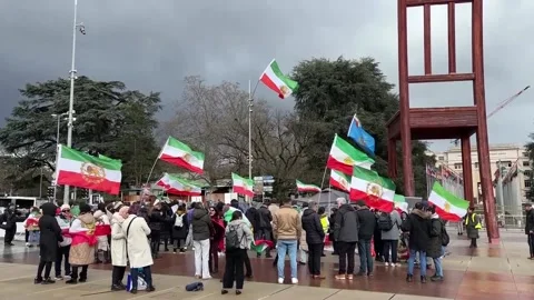 Pro-monarchy Iranians protest outside UN European headquarters in Geneva, GENEVA Stock Footage 329113597
