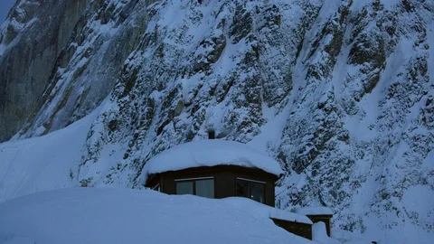 Pro mountaineers preparing and inside wooden hut in snowy land with mountains Stock Footage 129127251