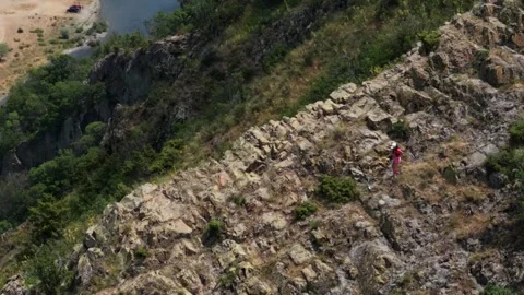 Pro runner climbing down a mountain 1 from drone Stock Footage 317237456