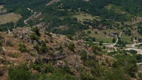 Pro runner climbing down a mountain 3 from drone Stock Footage 317237672