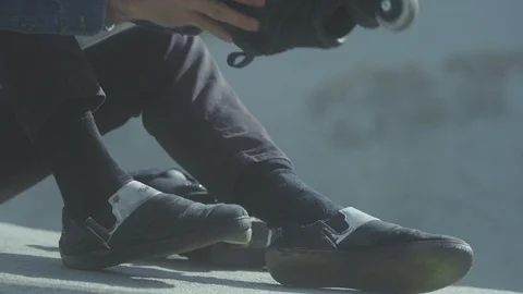 Pro skater putting on roller blades / inline skates (Right side) Stock Footage 127960874
