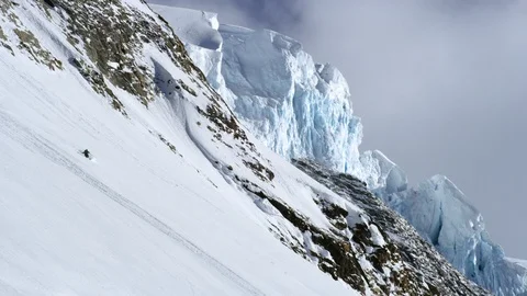 Pro skier freeride skiing down on snowy mountain, Tordrillo Mountain Stock Footage 129118599