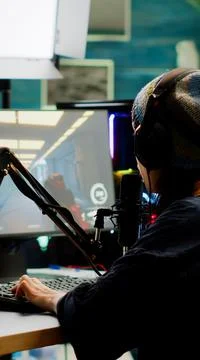 Pro streamer checking sound on mixer and putting on headset Stock Photos