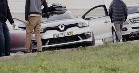 Pro surfer David Langer getting into car with friends on parking lot Stock Footage 164316935