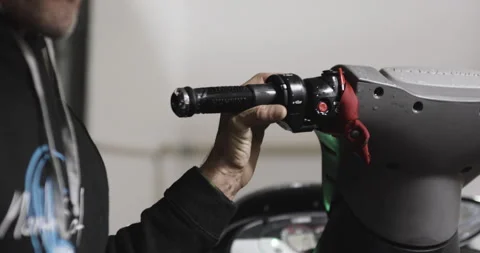 Pro surfer David Langer starting engine of water jet ski and listening Stock Footage 160584907