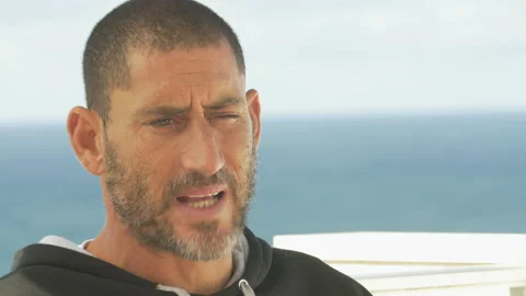 Pro surfer David Langer talking about his favourite thing about Portugal Stock Footage 157212918