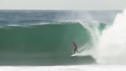 Pro surfer dropping into massive wave and tube rides Stock Footage 131270453